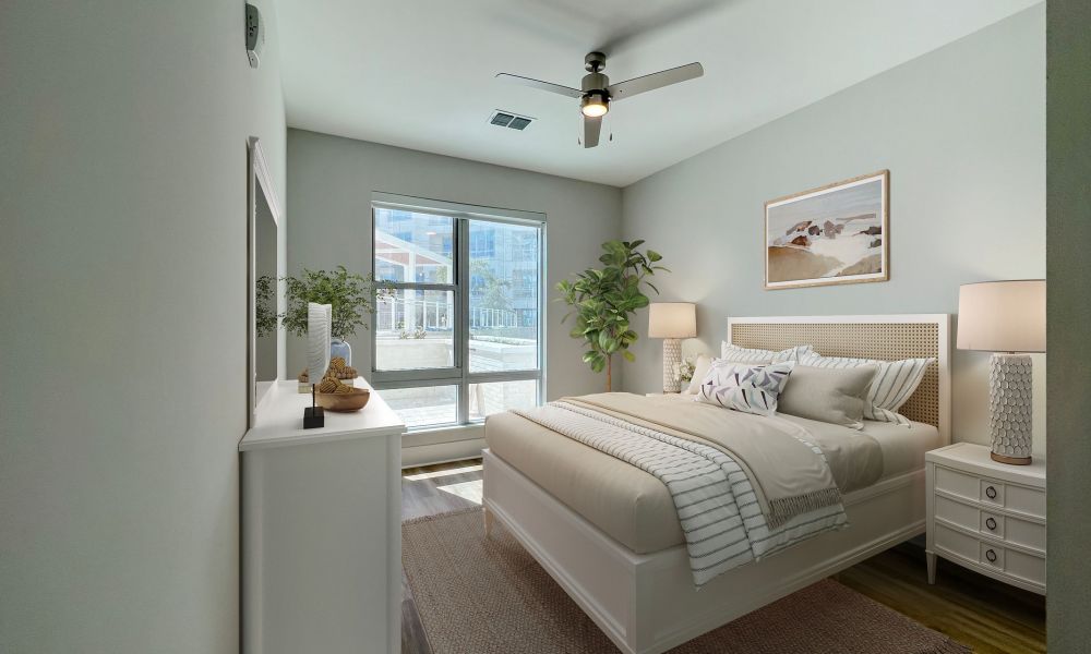 Spacious bedroom with king sized bed, large windows, and a light fixture at The Emerson On Rocky Point