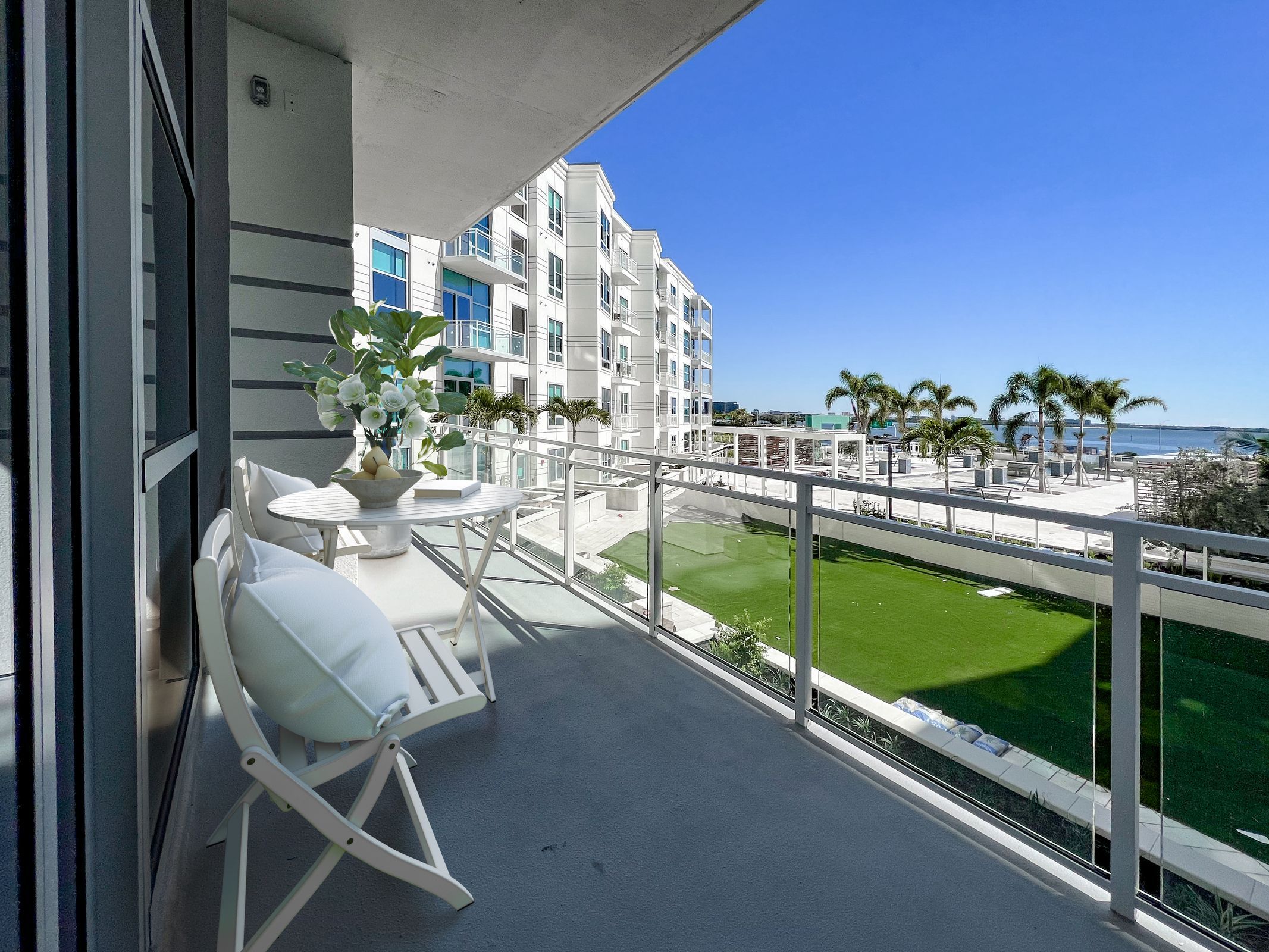 Spacious patio with furniture overlooking an outdoor courtyard at The Emerson On Rocky Point
