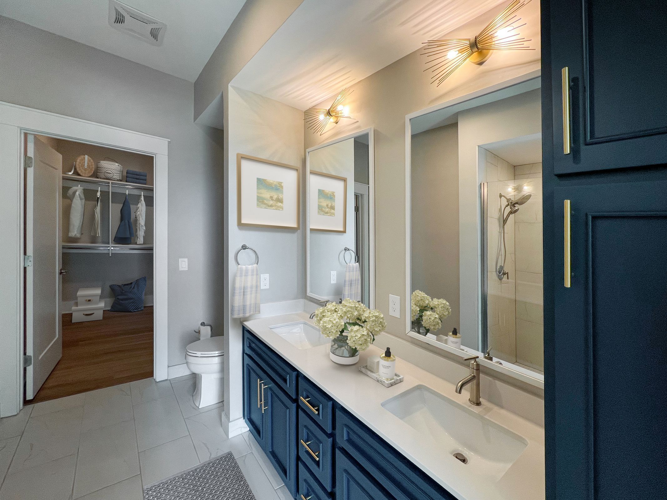 Spacious apartment bathroom with double vanities opening to a walk-in closet
