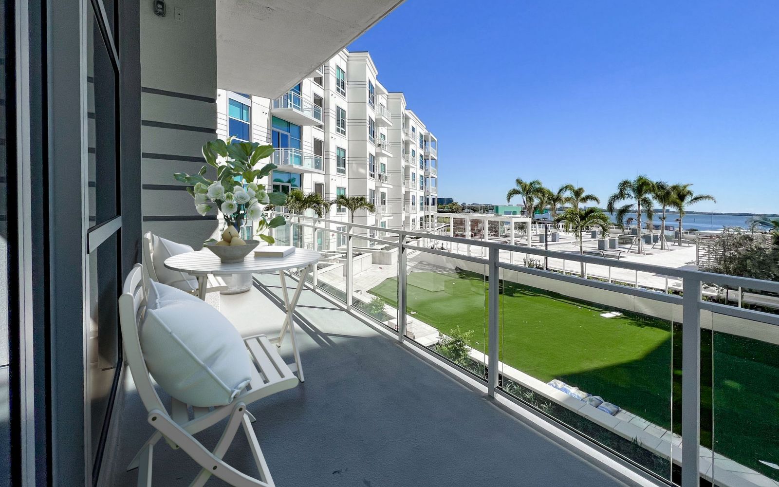 Spacious patio with furniture overlooking an outdoor courtyard at The Emerson On Rocky Point