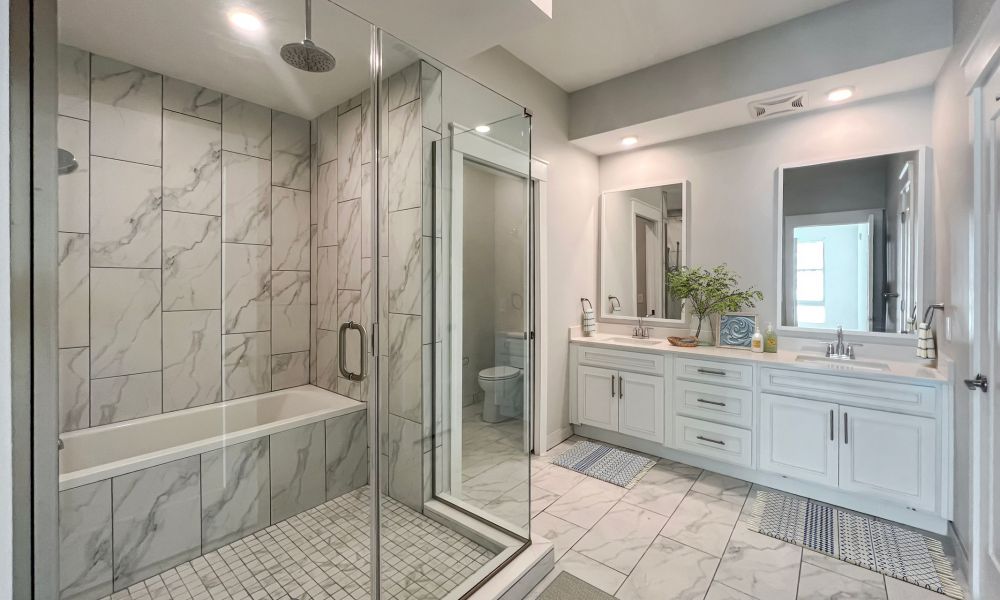 Euro bath tub within a large glass shower and double vanity sink at The Emerson On Rocky Point